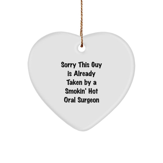 Oral Surgeon Gifts from Friends - Funny Quote Heart Ornament for Christmas, Sorry This Guy Is Already Taken By A Smokin' Hot Oral Surgeon - Image 1